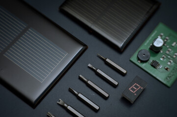 
A range of different electronic components and devices with dark tones, showcasing different...