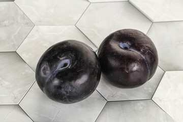 Two ripe sweet black plums