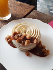 Irresistible Indulgence: Magnificent Pastry with Vanilla Mousse, Drizzling Caramel, and Peanut Crunch - Gourmet Delight for Sweet Connoisseurs