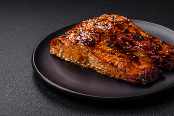 Delicious red salmon fish grilled with sauce and sesame, spices and herbs