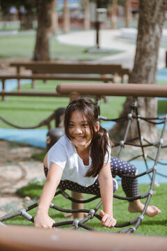 Young asian woman practicing yoga in the park. Healthy lifestyle concept.