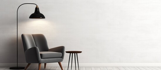 A black and white photo showing a modern black chair and a stylish lamp placed in a poster frame mounted on a white wall. The chair is sleek in design, and the lamp adds a touch of sophistication to