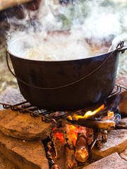 cooking in a cauldron on fire