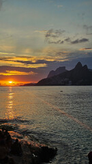  Vertical shot of a sunset over Ipanema and Leblon beach taken from Arpoador in Rio de Janeiro.