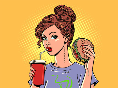 The girl eats a burger and soda. Appetizing fast food and high-quality delivery. Seasonal offerings of delicious new restaurant food menus.