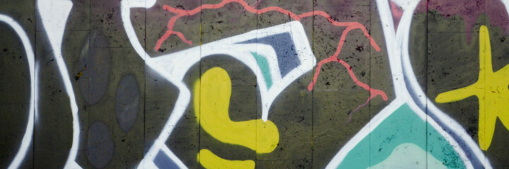 Colorful background of graffiti painting artwork with bright aerosol outlines on wall. Old school...