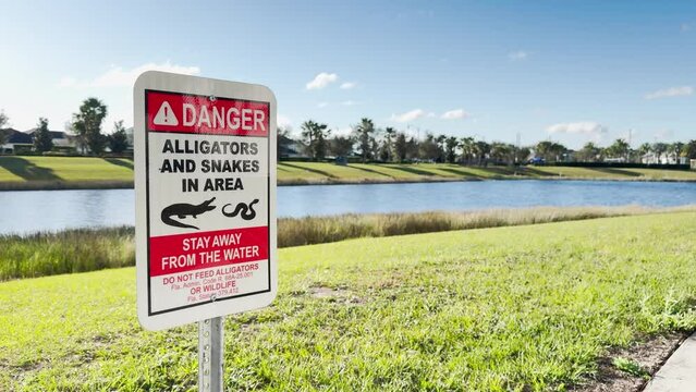 Signs around the lakes in Orlando.
Danger. Alligators and snakes in the area. Stay away from water.
