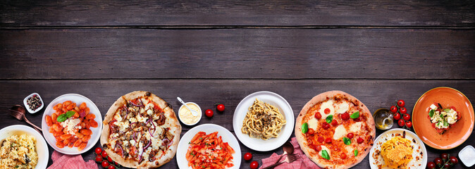 Delicious Italian food bottom border. Mixture of pizzas, pastas, gnocchi, risotto and bruschetta. Top view on a dark wood banner background. Copy space. - 754469290