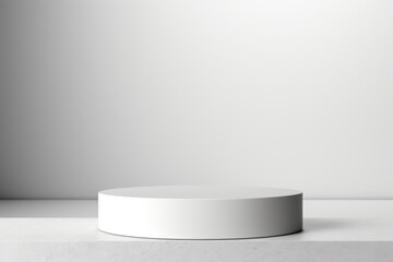 A clean and minimalist white pedestal on a white surface. Suitable for product display
