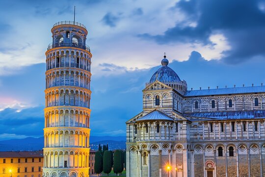 A serene evening scene of the Leaning Tower of Pisa illuminated against a dusky sky