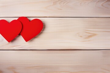 Couple of red paper hearts on a light wooden background, concept for love and romance.