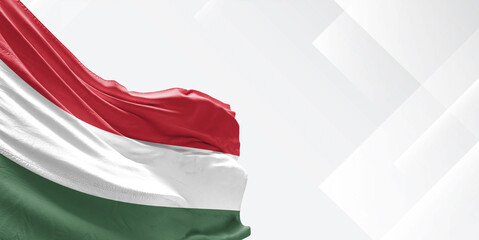 Hungary national flag cloth fabric waving on beautiful white Background.