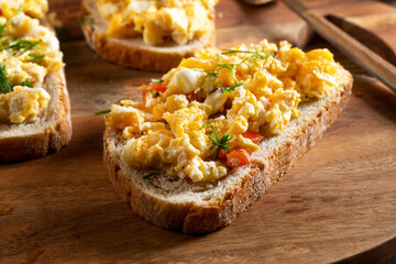 Scrambled eggs on a slice of bread.