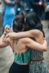 Women embracing while dancing.