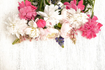 Bunch of white and pink peonies on a white wooden background; Wedding or birthday concept