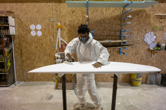 Shaper working on surf board