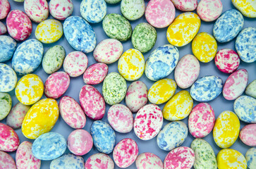 Fototapeta na wymiar Small multicolored Easter eggs. Spring background. View from above. Flat lay.