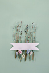 Dried lavender, egg shaped candies, white label on a green background. Easter concept. Greeting card design.