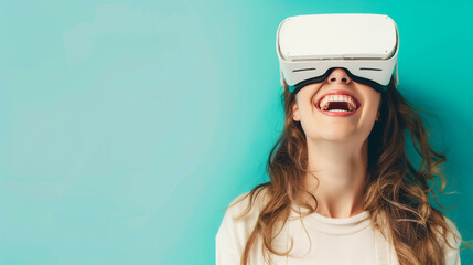 Close-up of a young laughing woman wearing white augmented virtual reality glasses on a studio blue background - obrazy, fototapety, plakaty