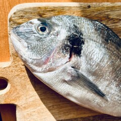 raw Dorado fish lies close on a wooden board. cooking at home. view from above. healthy food . fish head