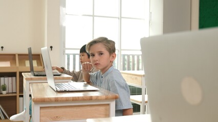 Caucasian smart child programing software system and learning about coding while multicultural...