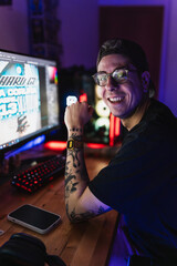 Graphic designer smiling while working on his home workplace