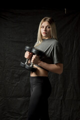 Portrait of a young beautiful blonde sportswoman in the gym.