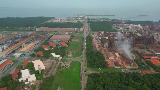 Aerial view of Barcarena's industrial zone, featuring major facilities like aluminum factory and alumina refinery, with the port in the backdrop