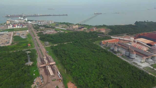 Aerial drone view of the connection between the port and the alumina refinery in industrial zone of Barcarena, Para state, Brazil