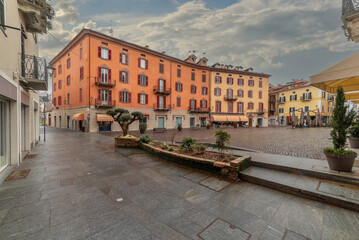 Mondovi, Italy - March 09, 2024: Cesare Battisti Square in Breo village with historic colorful...