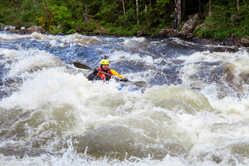Kayaker in whitewater on a Karelian river