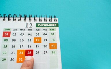 Dedo de una persona apuntando el 25 de Diciembre del 2025 la fecha de navidad en un calendario