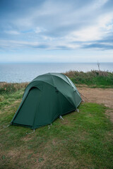 Tent on a cliff by the sea