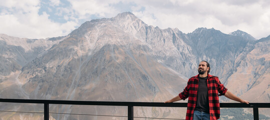 A man on the background of an autumn mountain landscape.