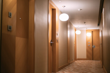 The empty, brightly lit corridor of the hotel. No one, no people.