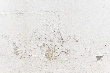 Peeling painted concrete wall. Leaking rain cause the wall and ceiling cracked. Water damaged the wall.