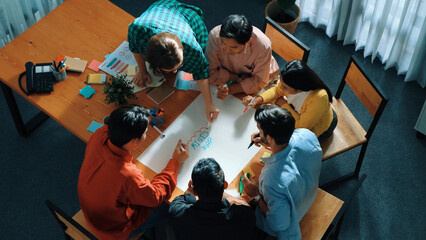 Top down view of smart business team in casual cloth brainstorming marketing idea and writing mind map together. Professional creative people using mind map to share and exchange idea. Convocation.