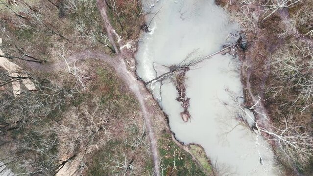 Drone point of view of a stream bypassing old, broken dam on West Hickman Creek in Veterans park of Lexington, KY