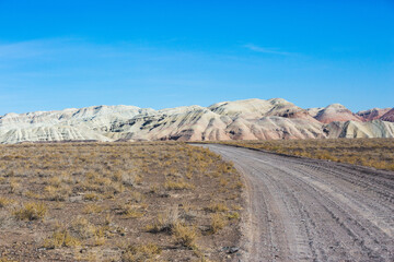 Road to Multicolored Aktau mountains in the Altyn Emel National Park. Kazakhstan - 754532877