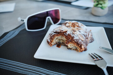 Coffee cycling ride. Cyclist enjoying buns and coffee in the cafe after riding. Cup coffee and cycling sunglasses on table