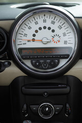 Close up of Mini Cooper dashboard with Speedometer, Odometer, and vehicle gauge