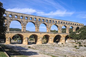 Ancient Roman bridge Pont du Gard over Gard river near Vers-Pont-du-Gard town, France
