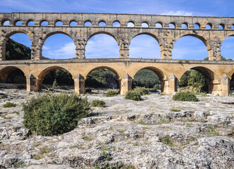 Ancient Roman bridge Pont du Gard over Gard river near Vers-Pont-du-Gard town, France