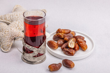 Hibiscus hot tea with dates. Traditional Ramadan Kareem concept snack for Iftar or Suhoor meal