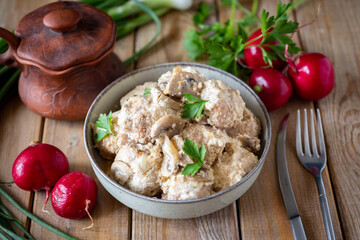 Dinner dish: meat meatballs with mushrooms in cream sauce. Close-up