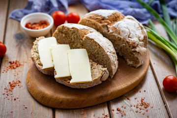 Homemade rye bread on a wooden background. Sandwich with butter made from homemade bread. Close-up
