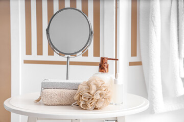 Bathing supplies and mirror on table  in bathroom