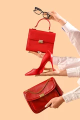 Stoff pro Meter Female hands with stylish women's bags, eyeglasses and high heels on beige background © Pixel-Shot