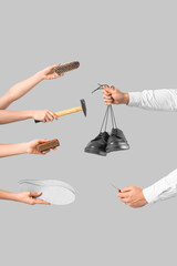 People with shoes, hammer, brushes and insoles on light background - obrazy, fototapety, plakaty