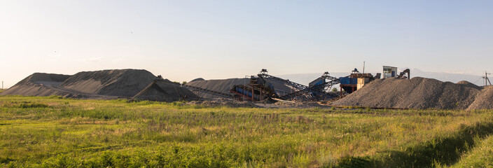 Heavy equipment works at a sand processing quarry